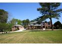 Beautiful home showcasing a sprawling front lawn, circular driveway, and manicured landscaping, offering curb appeal at 794 Rutland Ct, Lithonia, GA 30058