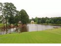 Scenic lake view with an American flag on the shoreline and lush greenery surrounding the tranquil water at 794 Rutland Ct, Lithonia, GA 30058