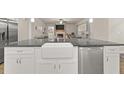 Kitchen island featuring a farmhouse sink and stainless steel dishwasher at 2316 Ridge View Dr, Loganville, GA 30052