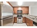 Well-equipped kitchen with stainless steel appliances and warm-toned cabinets offers functionality at 3650 Ashford Dunwoody Ne Rd # 514, Atlanta, GA 30319