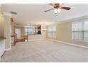 Open-concept living space with connecting kitchen, plush carpets and natural light at 5060 Windcrest Lane, Alpharetta, GA 30022