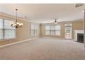 Spacious living room with plush carpet, fireplace and large windows with natural light at 5060 Windcrest Lane, Alpharetta, GA 30022