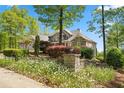Inviting exterior featuring stone accents, a manicured front garden, and an elegant entryway at 922 Florence Rd, Douglasville, GA 30134