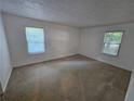 An empty room featuring neutral walls, carpet, and windows at 1150 Collier Nw Rd # 12F, Atlanta, GA 30318