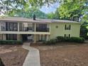 Two-story condo with stone accents, covered balconies, sidewalks and lush landscaping at 1150 Collier Nw Rd # 12F, Atlanta, GA 30318