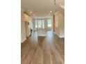 Bright, open-concept living space with recessed lighting, hardwood floors, and lots of natural light at 559 Fundao Ln # 21, Lawrenceville, GA 30046