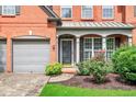Close up of a beautiful traditional brick home showcasing an inviting entrance and a two-car garage at 1065 Bookhout Drive Dr, Cumming, GA 30041