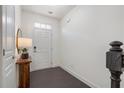 Welcoming foyer with dark wood floors, a white door and trim, and a charming wooden console table at 621 Hanlon Way, Alpharetta, GA 30009
