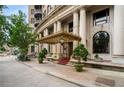 Ornate building exterior with a covered entryway, stately columns, and elegant landscaping at 75 Ponce De Leon Ne Ave # 1006, Atlanta, GA 30308