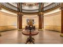Elegant lobby with a large round table, columns, high ceilings, and decorative details at 75 Ponce De Leon Ne Ave # 1006, Atlanta, GA 30308
