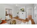 Cozy living room with a white brick fireplace, hardwood floors, and views of the dining area at 1633 Woodbine Ne Ave, Atlanta, GA 30317