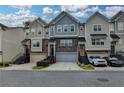 Attractive townhome exterior with varied colors, stone accents, front garages, and landscaped entryways at 2719 Hedgeway Cir, Kennesaw, GA 30144