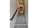 Carpeted stairs with white trim and wooden handrail lead upwards, open doorway at the top of the steps at 2719 Hedgeway Cir, Kennesaw, GA 30144