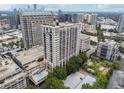 A lovely aerial view of the building and surrounding neighborhood, including a refreshing outdoor pool at 3040 Peachtree Rd, Atlanta, GA 30305