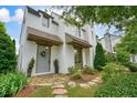 Home's inviting entrance features beautiful stone path and gray door, surrounded by manicured landscaping at 6930 Wesley Hughes Rd, Cumming, GA 30040