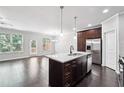 Open concept kitchen with granite counters, a center island, and stainless steel appliances at 5590 Bright Cross Way, Suwanee, GA 30024