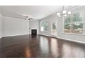 Spacious living room with hardwood floors, a fireplace, and plenty of natural light at 5590 Bright Cross Way, Suwanee, GA 30024