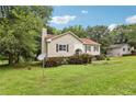 Charming split-level home featuring a well-manicured lawn, traditional siding, and decorative shutters at 73 Azalea Dr, Villa Rica, GA 30180