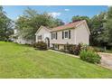 Charming split-level home featuring a well-manicured lawn, traditional siding, and decorative shutters at 73 Azalea Dr, Villa Rica, GA 30180
