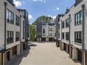 Exterior view of modern townhomes with brick and gray facade design, featuring private garages at 133 City View Ne Ct, Atlanta, GA 30308