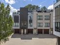 Detailed exterior of modern townhomes showcasing brick and gray facade with garages and stylish entrances at 133 City View Ne Ct, Atlanta, GA 30308