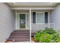 Inviting covered porch with decorative railing and colorful flowers at 1900 Tribble Ridge Dr, Lawrenceville, GA 30045