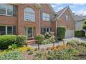 Charming brick home features a landscaped garden, a two-car garage, and a welcoming front entrance at 3675 Ridgeway Ter, Suwanee, GA 30024