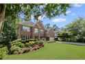 Beautiful brick home with a lush green lawn and professionally landscaped garden at 3675 Ridgeway Ter, Suwanee, GA 30024