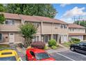 View of condo exterior with lush landscaping, visible unit numbers, and convenient parking at 1810 Ashborough Se Rd # G, Marietta, GA 30067