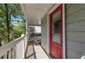 Covered front porch featuring a red front door and white railing at 2002 Shalimar Ne Dr, Chamblee, GA 30345