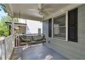 Relaxing front porch with a swing, ceiling fan, and great natural light, ideal for outdoor enjoyment at 2002 Shalimar Ne Dr, Chamblee, GA 30345