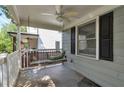 Cozy covered porch with ceiling fan and a charming porch swing at 2002 Shalimar Ne Dr, Chamblee, GA 30345