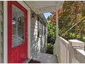 Exterior view of front porch with red door and painted railing at 2002 Shalimar Ne Dr, Chamblee, GA 30345
