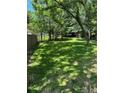 Spacious backyard with lush green grass and mature trees, perfect for outdoor activities at 2588 Abner Nw Pl, Atlanta, GA 30318