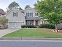 Charming two-story home with a well-manicured lawn and attached two-car garage at 522 Blue Mountain, Canton, GA 30114
