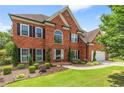 Charming brick residence showcasing manicured landscaping and a pristine, green lawn at 1219 Hadaway Ct, Lawrenceville, GA 30043