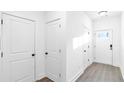Bright hallway with white doors, clean lines, and modern flooring at 1958 Dillon Dr, Lithonia, GA 30058