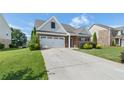 Beautiful front exterior showcasing well-maintained lawn, tasteful shrubbery, and attached two-car garage at 196 Al Jennah Blvd, Locust Grove, GA 30248