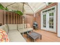 Cozy outdoor patio with seating, grill, and privacy fence at 3502 Village Green Dr, Roswell, GA 30075