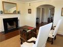 Bright living room featuring a fireplace, vintage trunk, and views to dining and kitchen at 284 Lakeview Ne Ave, Atlanta, GA 30305