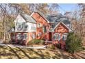 Lovely two-story brick home with blue shutters and a well-manicured lawn surrounded by trees at 340 Antebellum Way, Fayetteville, GA 30215
