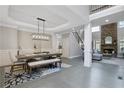 Open-concept dining area with modern lighting, hardwood floors, and staircase leading to the second floor at 3905 Greenside Ct, Dacula, GA 30019
