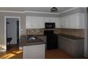 Well-equipped kitchen with granite countertops, stainless steel appliances, and ample cabinet space at 1205 Pebble Bend Dr, Grayson, GA 30017