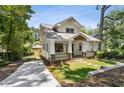 Beautiful craftsman home with a long driveway, lush landscaping, and inviting covered front porch at 4642 Orchid Dr, Pine Lake, GA 30072