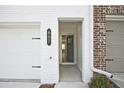 Close-up of townhouse entry, highlighting the door frame, brick accents, and address number at 687 Sunstone Ln, Lawrenceville, GA 30043