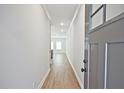 Inviting foyer with a long hallway, light hardwood floors and neutral paint scheme at 687 Sunstone Ln, Lawrenceville, GA 30043