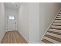 Open foyer featuring hardwood floors, staircase and access to front entry and the upper levels at 695 Sunstone Ln, Lawrenceville, GA 30043