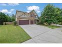 Charming two-story home with stone accents, a well-manicured lawn, and a spacious two car garage at 425 Eldridge Dr, Suwanee, GA 30024