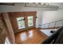 An aerial view showcasing the living room with hardwood floors, brick wall and staircase at 1596 Cleveland Ave # 301, East Point, GA 30344