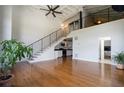 Spacious living room with hardwood floors, staircase to the loft, and open concept kitchen view at 1596 Cleveland Ave # 301, East Point, GA 30344